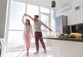 Young Couple Dancing In Kitchen, Lovely Asian Woman And Hispanic Man Royalty Free Stock Photo