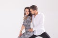 Young couple dancing latin dance bachata, merengue, salsa, kizomba. Two elegance pose over white background with copy