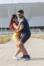 Young couple dancing Latino dance against urban landscape Royalty Free Stock Photo