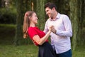 Young couple dancing in the park, holding hands Royalty Free Stock Photo