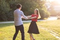 Young couple dancing in the park in the sunshine Royalty Free Stock Photo