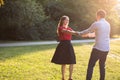 Young couple dancing in the park in the sunshine Royalty Free Stock Photo