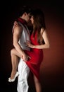 Young couple dancing passion on dark red light Royalty Free Stock Photo