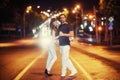 Young couple dancing on the road.