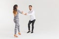 Young couple dancing social latin dance bachata, merengue, salsa. Two elegance pose on white background Royalty Free Stock Photo