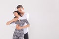 Young couple dancing social latin dance bachata, merengue, salsa. Two elegance pose on white background Royalty Free Stock Photo