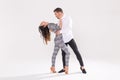 Young couple dancing social latin dance bachata, merengue, salsa. Two elegance pose on white background Royalty Free Stock Photo