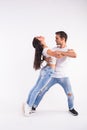 Young couple dancing social latin dance bachata, merengue, salsa. Two elegance pose on white background Royalty Free Stock Photo