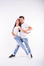 Young couple dancing social latin dance bachata, merengue, salsa. Two elegance pose on white background Royalty Free Stock Photo