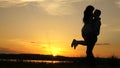 Young couple dancing at sunset on beach. Happy guy and girl waltz in evening in the summer park. Loving man and woman Royalty Free Stock Photo