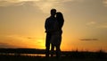 Young couple dancing at sunset on beach. Happy guy and girl waltz in evening in the summer park. Loving man and woman Royalty Free Stock Photo