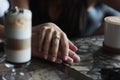 Young couple on date in cafe with cappuccino latte, hand in hand