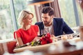 Young couple on date in restaurant sitting drinking wine cheers looking at each other tender Royalty Free Stock Photo