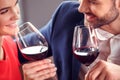 Young couple on date in restaurant sitting drinking wine flirting cheerful close-up Royalty Free Stock Photo