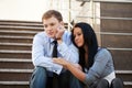 Sad young couple in depression sitting on the steps Royalty Free Stock Photo