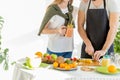 Young couple dicing fruit in the kitchen Royalty Free Stock Photo