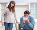 Young couple disappointed with price in furniture store