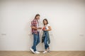 Young couple discussing the color for walls and looking involved