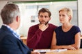 Meeting with their financial advisor. Young couple discussing investment plans with a financial advisor. Royalty Free Stock Photo