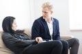 Young couple disputing problem while sitting on sofa