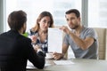 Young couple is dissatisfied with terms of contract Royalty Free Stock Photo