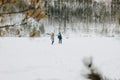 The young couple with dog haski at forest nature park in winter. Travel adventure concept Royalty Free Stock Photo