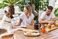 Young couple with dog smiling happy having breakfast at terrace Royalty Free Stock Photo