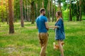 young couple with a dog walking along the autumn park Royalty Free Stock Photo