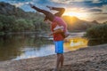 Young couple doing acrobatics yoga at sunset