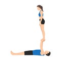 Young couple doing acroyoga. Woman balancing on raised arms of man lying on floor