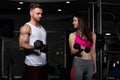 Young Couple Doing Exercise For Biceps With Dumbbells Royalty Free Stock Photo