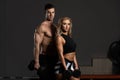 Young Couple Doing Exercise For Biceps With Dumbbells Royalty Free Stock Photo