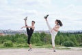 Young couple doing a high kick, street dance, ballet, dancing steps, movements Royalty Free Stock Photo