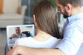 Young couple doing video conference with doctor on laptop. Online consultation