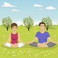 Young couple doing yoga exercise in park in summer