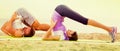 Young couple doing yoga poses sitting on sunny beach Royalty Free Stock Photo