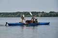 Going kayak boating with dogs on river, active pets concept, happy dog and owner on adventure. Young couple with dreadlocks having Royalty Free Stock Photo