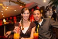 Young couple drinking cocktails in bar