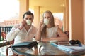 Young couple drinking coffee on a balcony Royalty Free Stock Photo