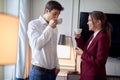 Young couple drinking coffee in the hotel room at their business trip. Hotel, business, people Royalty Free Stock Photo