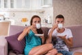 Young Couple Drinking Coffee on Sofa at Home Royalty Free Stock Photo