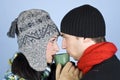 Young couple drinking hot drink from same cup Royalty Free Stock Photo