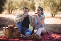 Young couple drinking red wine while sitting at farm Royalty Free Stock Photo