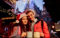 Young couple with drinks on Christmas market