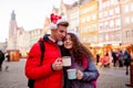 Young couple with drinks on Christmas market