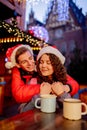 Young couple with drinks on Christmas market