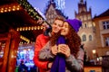 Young couple with drinks on Christmas market