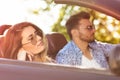 Young Couple Driving Along Country Road In Open Top Car Royalty Free Stock Photo