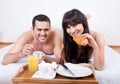 Young couple eating breakfast in bed Royalty Free Stock Photo