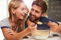 Young Couple Eating Breakfast In Kitchen Together Royalty Free Stock Photo